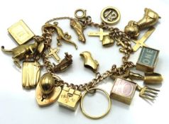 A 9ct gold charm bracelet with various charms incl