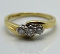 An 18ct gold three stone ring set with approx. 0.3