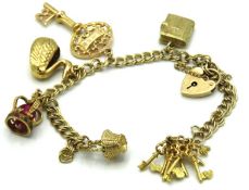 A 9ct gold charm bracelet, swan & crown test elect