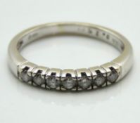An 18ct white gold half eternity ring set with 0.2