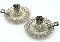A pair of late 19thC. 0.800 silver chambersticks,