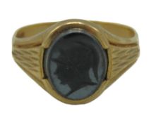 A 9ct gold signet ring set with hematite with carv