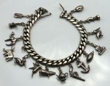 A silver curb link charm bracelet including boxing