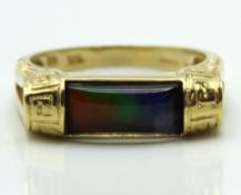 An 18ct gold ammolite bar ring with Greek key decor, 5g, size V