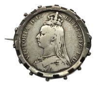 An 1899 Victoria silver crown, mounted in white me