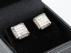 A pair of 14ct white gold stud earrings with screw
