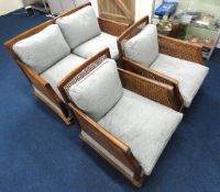 A compact three piece walnut & cane Bergere style