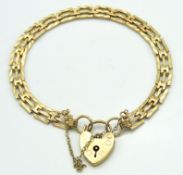A 9ct gold three bar gate bracelet with padlock, 1