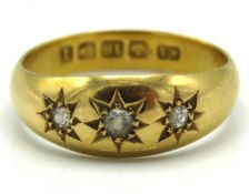 An Edwardian 18ct gold three stone diamond ring of