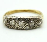 An antique 18ct gold ring set with five main diamo