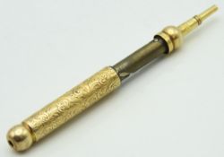 An antique mechanically propelled yellow metal pen