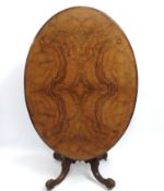 A Victorian walnut tilt top breakfast/dining table