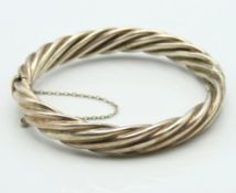A vintage sterling silver rope twist hinged bangle