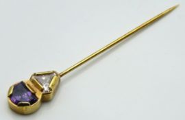 An 18ct gold tie pin set with amethyst & white sto