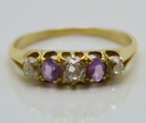 An antique yellow metal ring set with amethyst & a