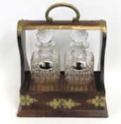 A 19thC. walnut & brass Tantalus with plated label