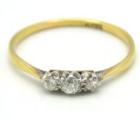 An antique 18ct gold three stone diamond ring of a