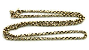 An antique yellow metal chain with two small brass