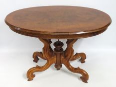 A Victorian walnut dining table with ornate legs,