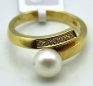 A 18ct gold ring set with five small diamonds of 0
