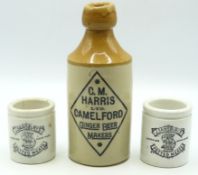 A C.M Harris Camelford stoneware ginger beer bottle, 172mm high, twinned with two Sainsbury's potted