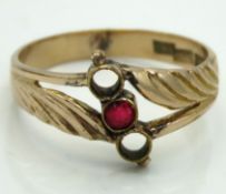 An 18ct gold ring set with ruby lacking two other