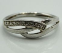 A 9ct white gold ring set with small diamonds, 1.3