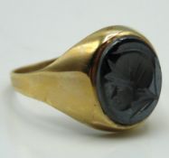 A 9ct gold signet ring with carved hematite centur