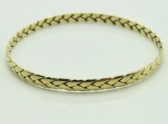 A 9ct gold bangle of woven design, internal measur