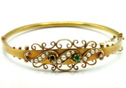 An antique 15ct gold bangle of decorative form set
