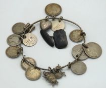 A silver & white metal coin bracelet twinned with