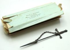 A white metal jabot pin with possibly original jew