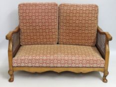 A compact three piece light oak framed Bergere sty
