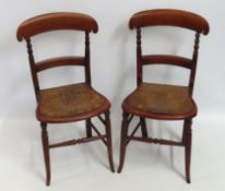 A pair of Estonian dining chairs with punched seat