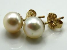 A pair of 14ct gold post fit earrings set with 7mm