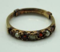 A 9ct gold garnet & pearl half eternity ring with