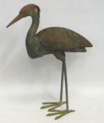 A bronze-finished metal crane or heron statue as a