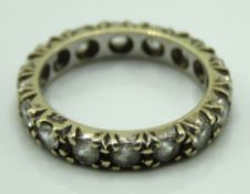 A 9ct gold eternity ring set with topaz, 2.9g, siz