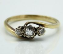 A yellow metal cross over style ring set with appr