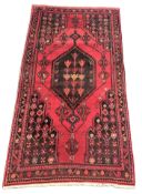 A Persian hand knotted woollen Hamadan rug, 2490mm