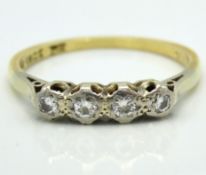 An antique 18ct gold ring set with four platinum mounted illusion set diamonds of approx. 0.18ct, 2.
