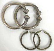 A pair of tribal manila style white metal bangles
