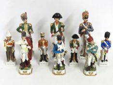 A quantity of porcelain military figurines, talles