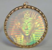 A yellow metal mounted hologram pendant depicting