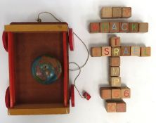 A 1950s child's pull along wooden toy with spellin