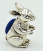 A sterling silver rabbit pin cushion, 22mm tall, 9