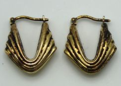 A pair of 9ct gold hoop earrings, fire damaged, 21