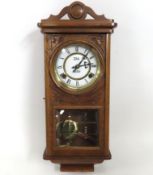 An oak cased wall clock, 540mm tall