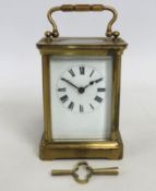 A brass carriage clock with key, 140mm tall includ
