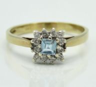 A 9ct gold ring set with aquamarine & approx. 0.12